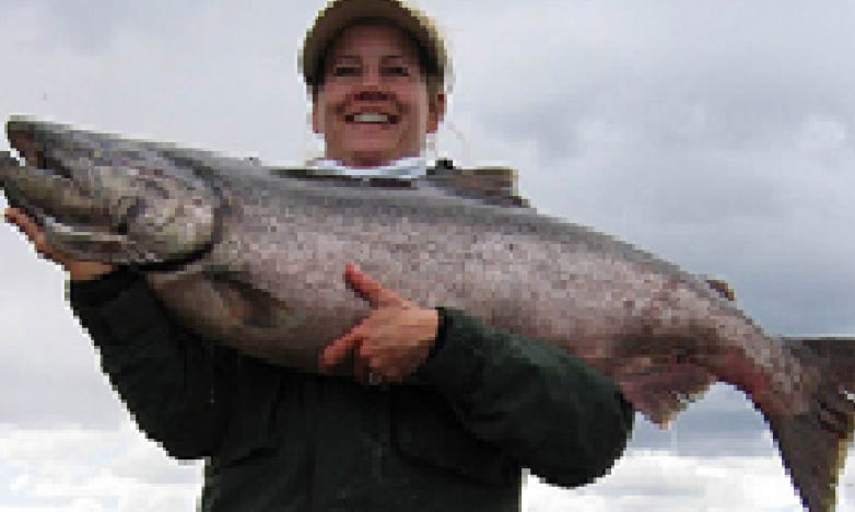 Hugging a huge Alaskan salmon